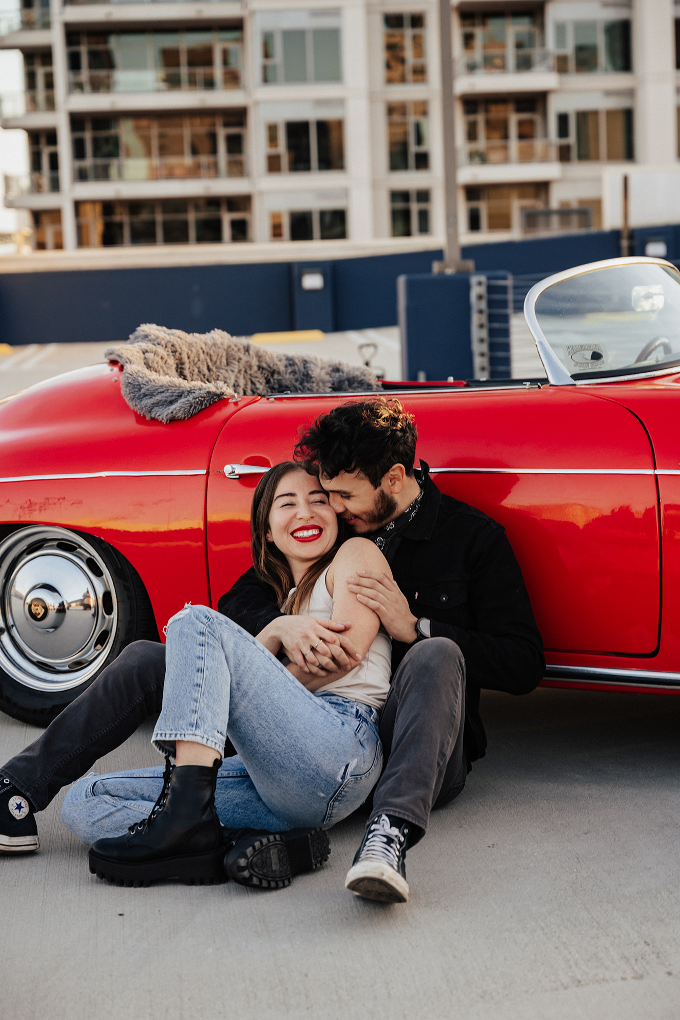 adorable couple in front of vintage Porsche
